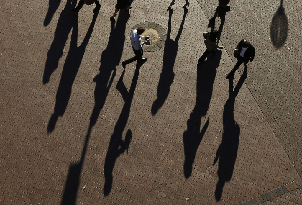 Not enough young people are present in boardrooms and leadership positions to reflect modern society and its cultural behaviours. Pictured: Commuters cast their shadows as they arrive to the Central Business District at the morning rush hour in Sydney July 1, 2013.