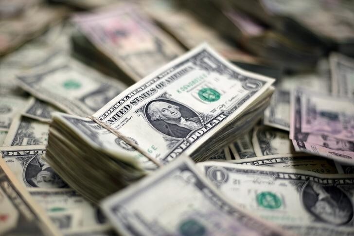 U.S. Dollar banknotes are seen in this photo illustration taken February 12, 2018. REUTERS/Jose Luis Gonzalez/Illustration