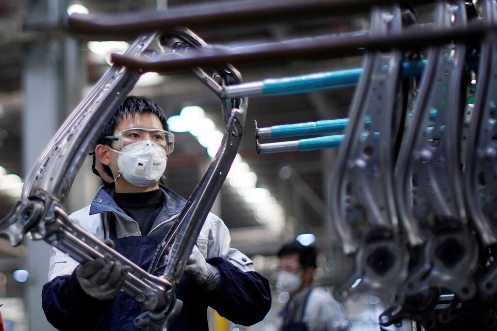 An employee wearing a face mask works on a car seat assembly line at Yanfeng Adient factory in Shanghai, China, as the country is hit by an outbreak of a new coronavirus, February 24, 2020. REUTERS/Aly Song - RC2X6F9Q2JMC