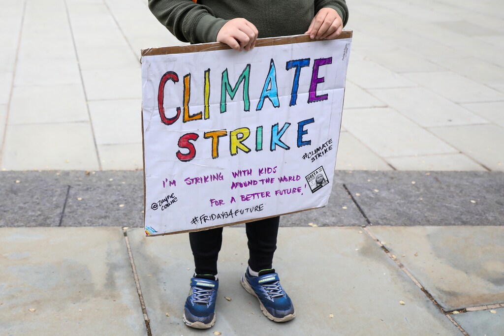 A participant holds a placard during a protest to call for urgent action to slow the pace of climate change in New York, U.S., May 3, 2019. REUTERS/Brendan McDermid