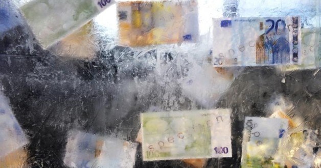 Image: Fake euro banknotes are seen in a block of ice symbolizing austerity measures, during a demonstration by trade unions and workers in central Brussels February 21, 2013. REUTERS/Eric Vidal