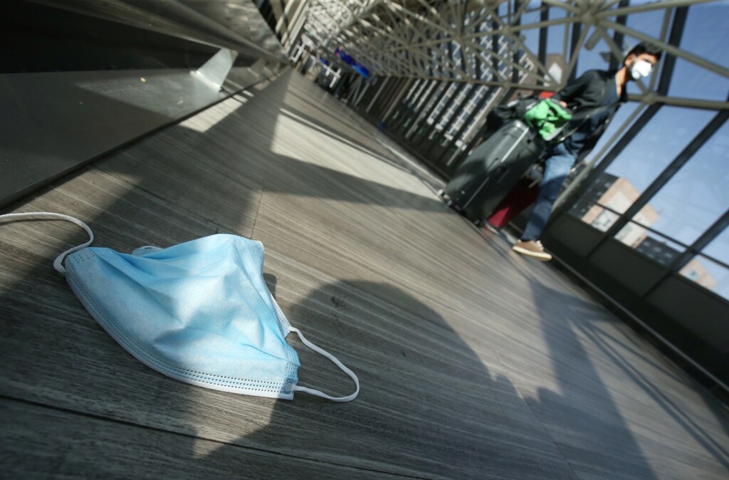 A sanitary mask lies on the ground at Frankfurt Airport