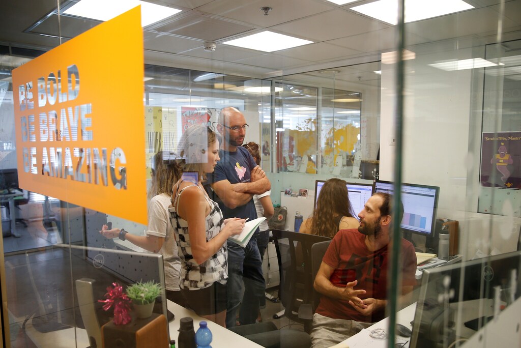 Employees work at website-designer firm Wix.com offices in Tel Aviv, Israel July 4, 2016. Picture taken July 4, 2016. REUTERS/Baz Ratner - RTX2JR88