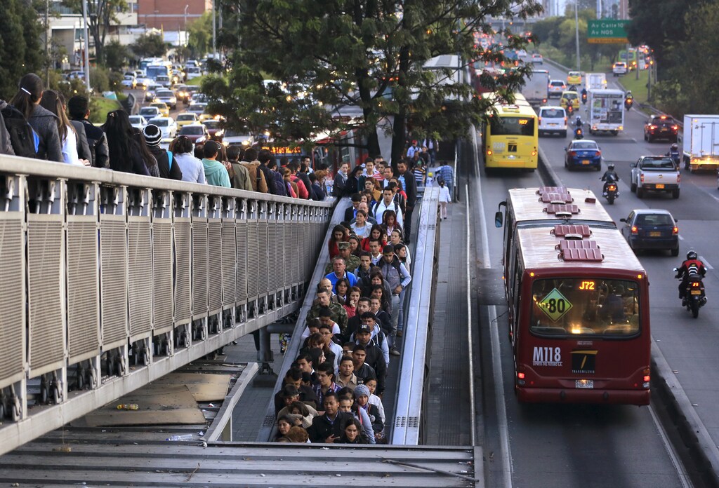 Public transport commuters line up at a station during rush hour ahead of local elections in Bogota, October 20, 2015.