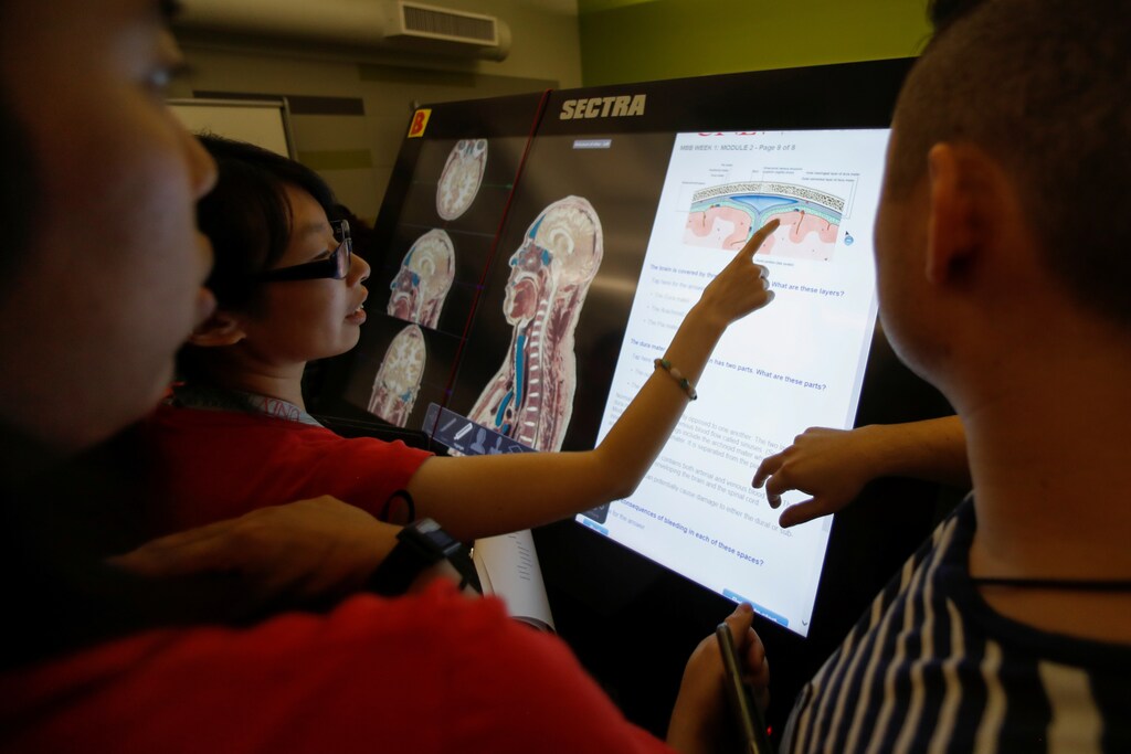 First-year medical student Doris Chan makes a point as she participates with classmates in the virtual anatomy class at the UNLV School of Medicine in Las Vegas, Nevada, U.S., August 27, 2018. Picture taken August 27, 2018. REUTERS/Mike Blake - RC19F4B4C4F0