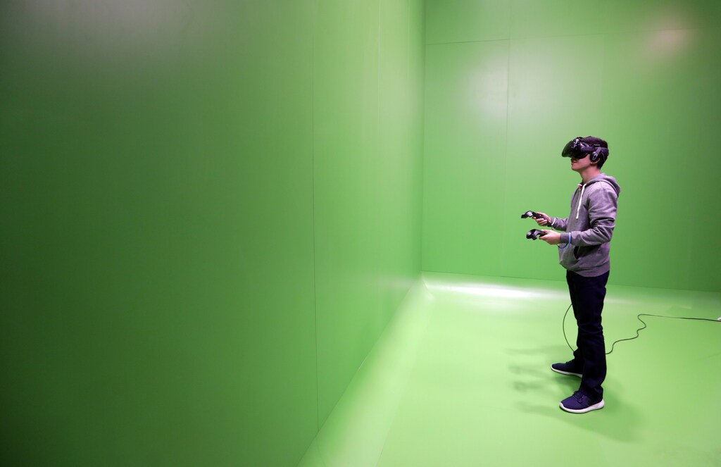 A visitor tries a virtual reality headset during Mobile World Congress in Barcelona, Spain, February 28, 2017