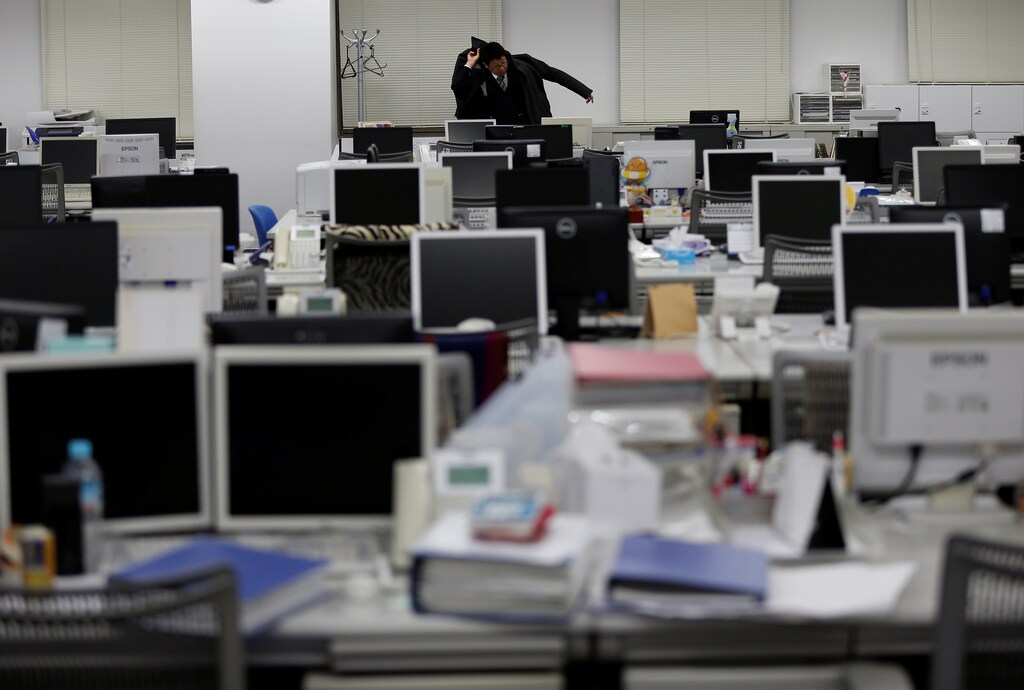 A company employee prepares to leave the office after working hours on the company's "no-overtime day" in Tokyo, Japan February 15, 2017. Picture taken February 15, 2017. REUTERS/Issei Kato - RC18596C87A0