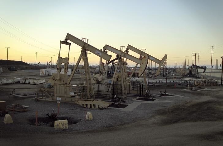 Oil rig pumpjacks, also known as thirsty birds, extract crude from the Wilmington Field oil deposits area where Tidelands Oil Production Company, which is owned by Occidental Petroleum Corporation (Oxy), operates near Long Beach, California July 30, 2013. Occidental Petroleum posted a smaller-than-expected quarterly profit on Tuesday, hurt by lower oil prices in the Middle East and North Africa, where the fourth-largest U.S. oil company is considering an exit. REUTERS/David McNew (UNITED STATES - Tags: ENERGY BUSINESS)