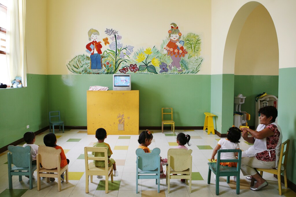 Children watch television at the Puericultorio Perez Aranibar children's home in Lima March 9, 2012. The home, the biggest of its kind in Peru with 82 years of history, provides a shelter for more than 400 children who are abandoned, orphaned, homeless or in dire need. REUTERS/Enrique Castro-Mendivil (PERU - Tags: SOCIETY) - RTR2Z4GO