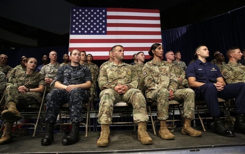 Members of the U.S. military listen as U.S. President Donald Trump announces his strategy for the war in Afghanistan during an address to the nation from Fort Myer, Virginia, U.S., August 21, 2017. REUTERS/Joshua Roberts - UP1ED8M04P4EC