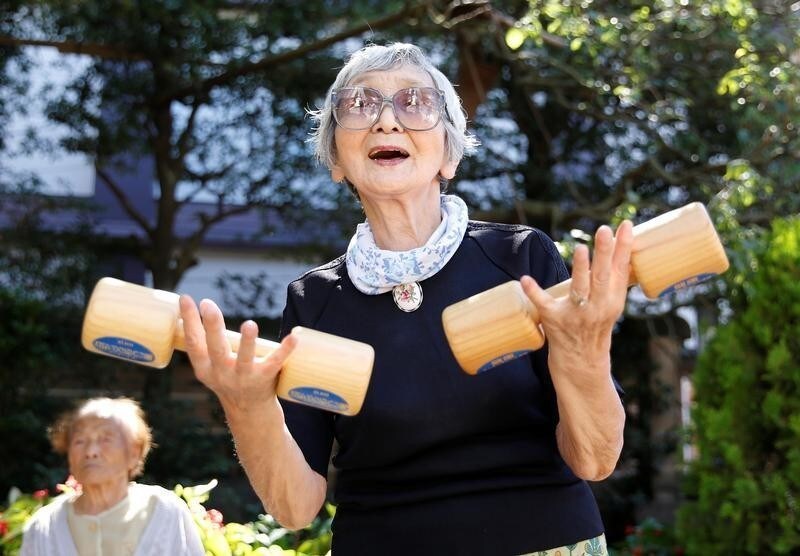 Elderly and middle-aged people exercise with wooden dumbbells during a health promotion event to mark Japan's "Respect for the Aged Day" at a temple in Tokyo's Sugamo district, an area popular among the Japanese elderly, Japan, September 18, 2017. REUTERS/Toru Hanai - RC1C0651C800