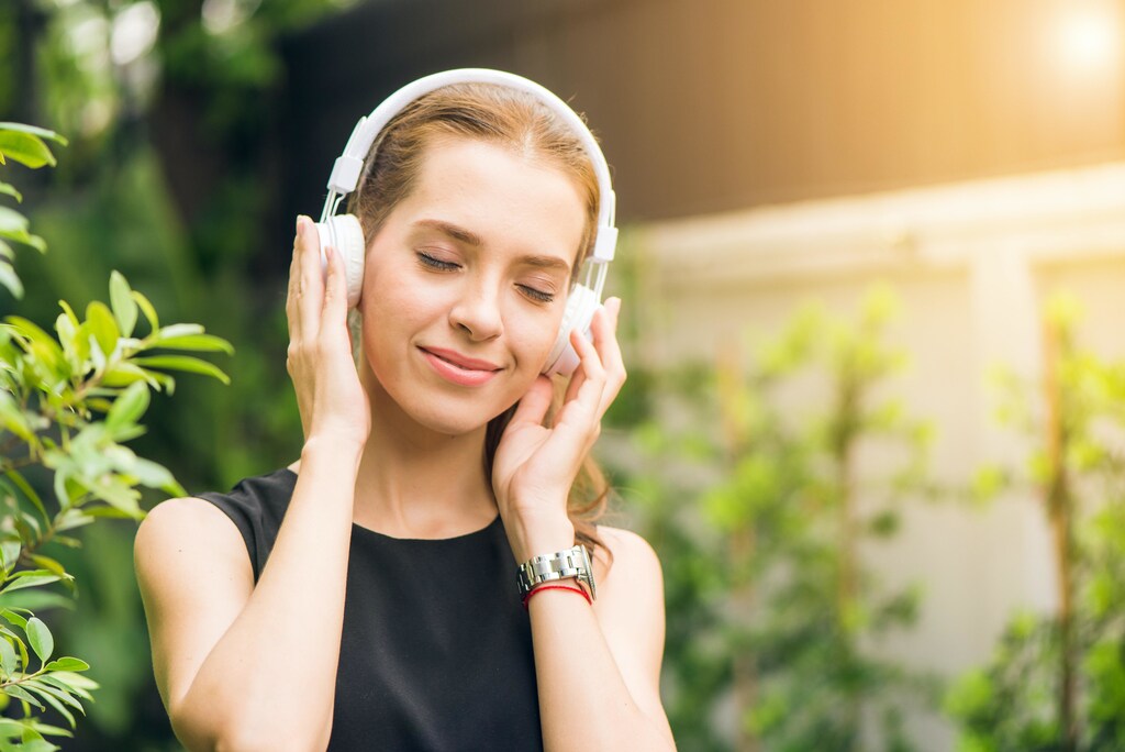 Woman listening to music through headphones
