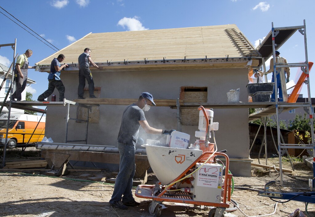 Labourers working to renovate a house.