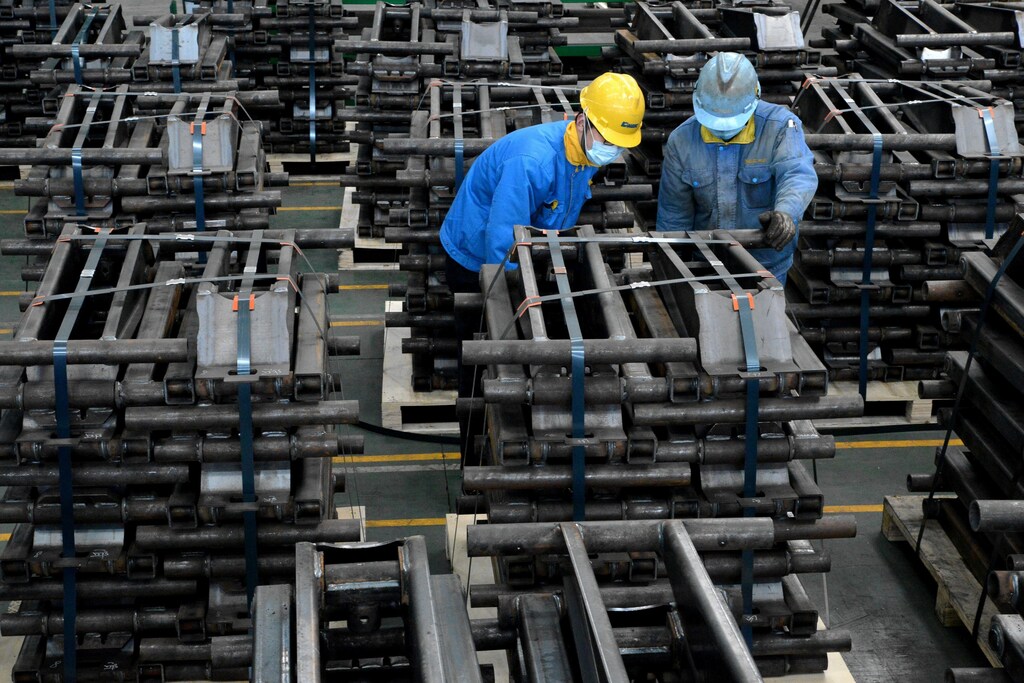 Workers wearing face masks are seen on a production line manufacturing parts for trailers to be exported to the U.S. at a factory, as the country is hit by an outbreak of the novel coronavirus disease (COVID-19), in Taizhou, Jiangsu province, China March 28, 2020. Picture taken March 28, 2020. China Daily via REUTERS ATTENTION EDITORS - THIS IMAGE WAS PROVIDED BY A THIRD PARTY. CHINA OUT. - RC29UF94W6W0