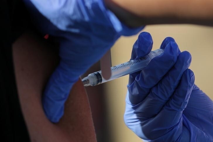 A homeless person is flu vaccinated as she registered to enter as transitional camp area for homeless people at the city's works yard in San Diego, California, U.S., October 9, 2017. REUTERS/Mike Blake