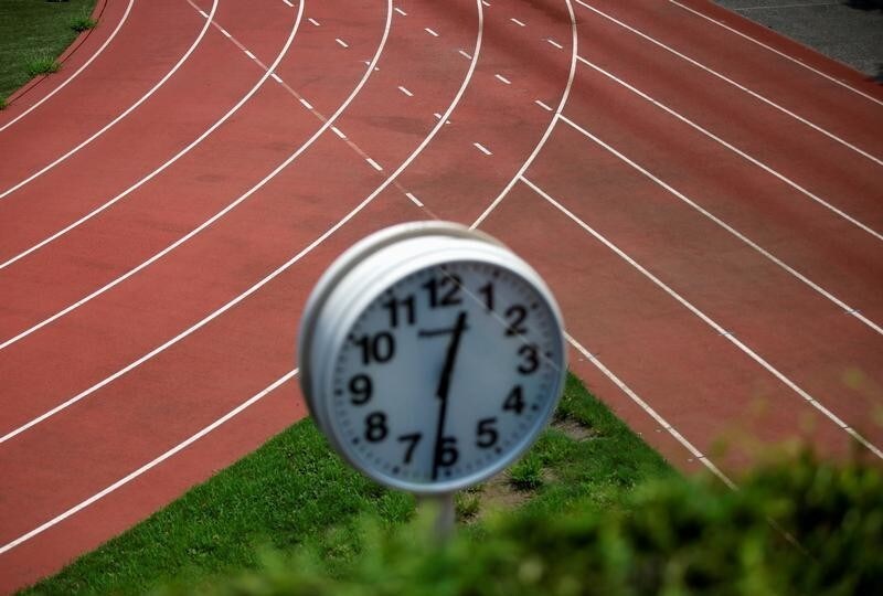 Running track are seen through a clock tower near the construction site of the New National Stadium, the main stadium of Tokyo 2020 Olympics and Paralympics, in Tokyo, Japan August 6, 2018.
