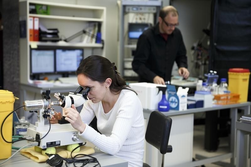 Scientists work in the laboratory of Professor Henry Markram (not pictured) head of the Human Brain Project during a media tour after a new conference at the Swiss Federal Institute of Technology (EPFL) in Ecublens, near Lausanne January 29, 2013. The Human Brain Project with a cost estimated at 1.19 billion Euros is one of the two FET Flagship projects selected by the European Commission on January 28, 2013. The project expected to be carried out over 10 years will federate over 80 international research institutions working for a better understanding of the brain and its fundamental mechanisms using supercomputer based models and simulations.