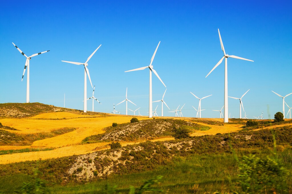 green investment - Wind farm at farmland. Aragon, Spain