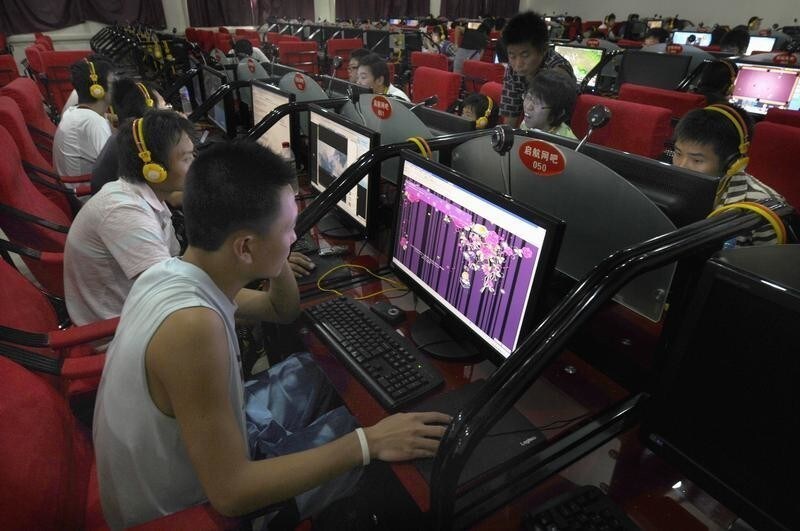 A customer looks at a web page of Qzone, a Chinese social networking site at an internet cafe in Changzhi, Shanxi province August 28, 2009. From virtual clothes to e-pets, Asians spend an estimated $5 billion a year on virtual purchases via websites such as Qzone, Cyworld in South Korea and mobile-phone based network Gree in Japan, according to Plus Eight Star. That's about 80 percent of the global market for virtual products, it says.