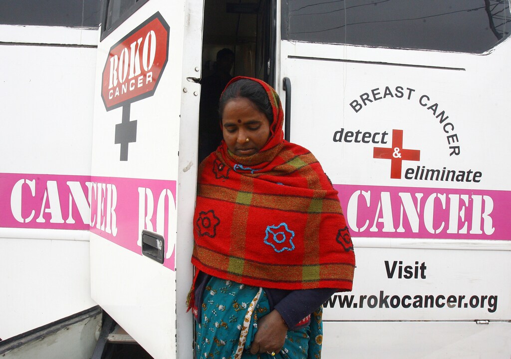 A woman comes out from a mobile cancer detection unit after her mammography examination during a free medical check-up camp in a slum area in the northern Indian city of Chandigarh February 6, 2011. Since 2005 -2010, a total of 15,467 people have undergone breast cancer screening in India and 691 cases reported positive and are taking treatments for the disease at various hospitals, an official at the camp said. REUTERS/Ajay Verma (INDIA - Tags: HEALTH) - GM1E7261J8E01