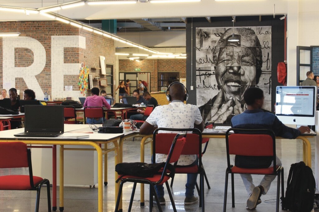 People studying in an open-plan room, illustrating changing educational needs
