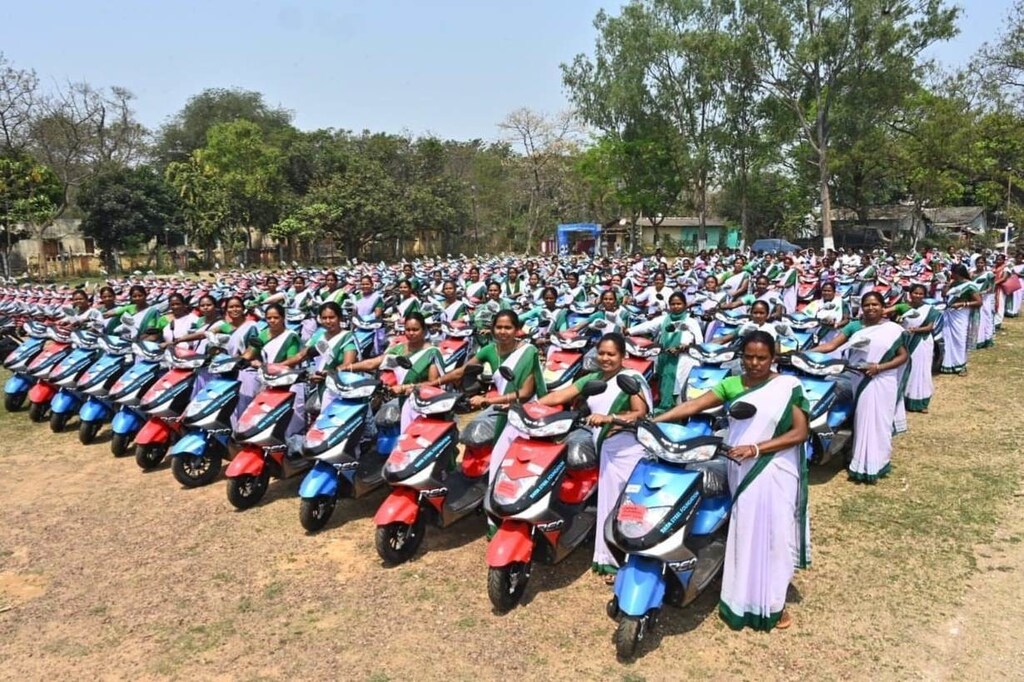 Healthcare workers pose with their new e-scooters in West Singhbhum district of Jharkhand, India