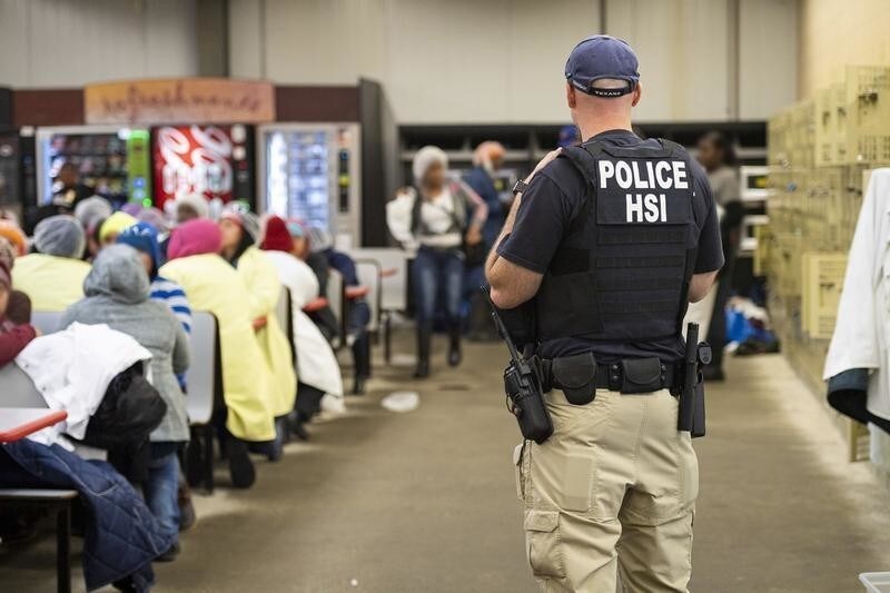 Homeland Security Investigations (HSI) officers from Immigration and Customs Enforcement (ICE) look on after executing search warrants and making some arrests at an agricultural processing facility in Canton, Mississippi, U.S. in this August 7, 2019 handout photo. Immigration and Customs Enforcement/Handout via REUTERS ATTENTION EDITORS - THIS IMAGE WAS PROVIDED BY A THIRD PARTY. - RC153B4D8800