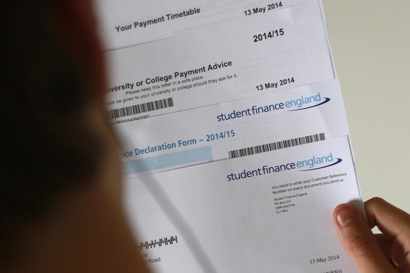 A student poses with his university loan paperwork from Student Finance England, in this picture illustration taken in London May, 24, 2014 during his examination period for university entry. Early in 2014 local media reported a fall of 17% undergraduate numbers in the first year of the higher tuition fees where, from 2012-13 universities could charge up to ?9000 ($15,147) yearly fees, trebling previous amounts.