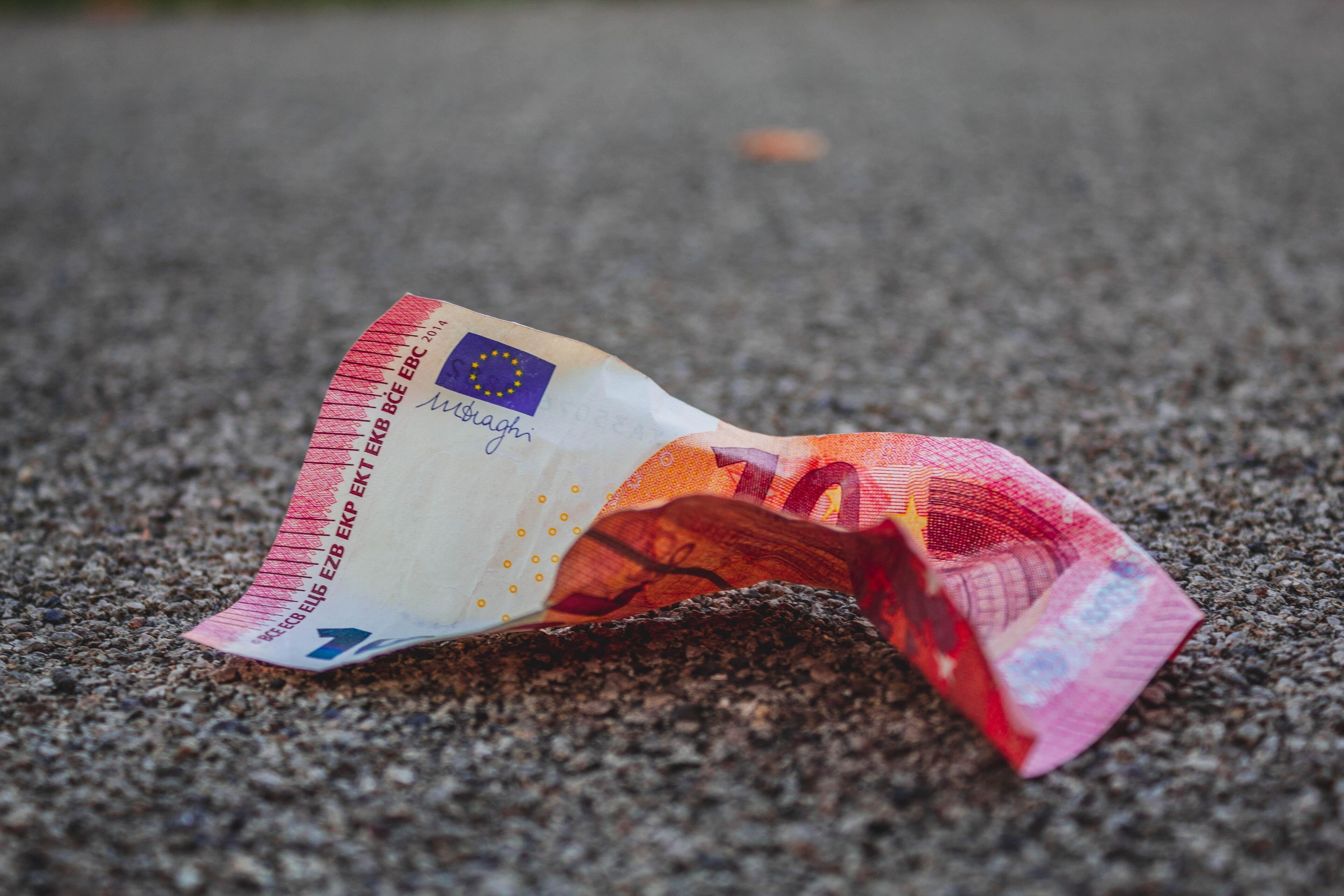 A ten euro note is discarded on the street - suggesting it's devaluation as a result of inflation