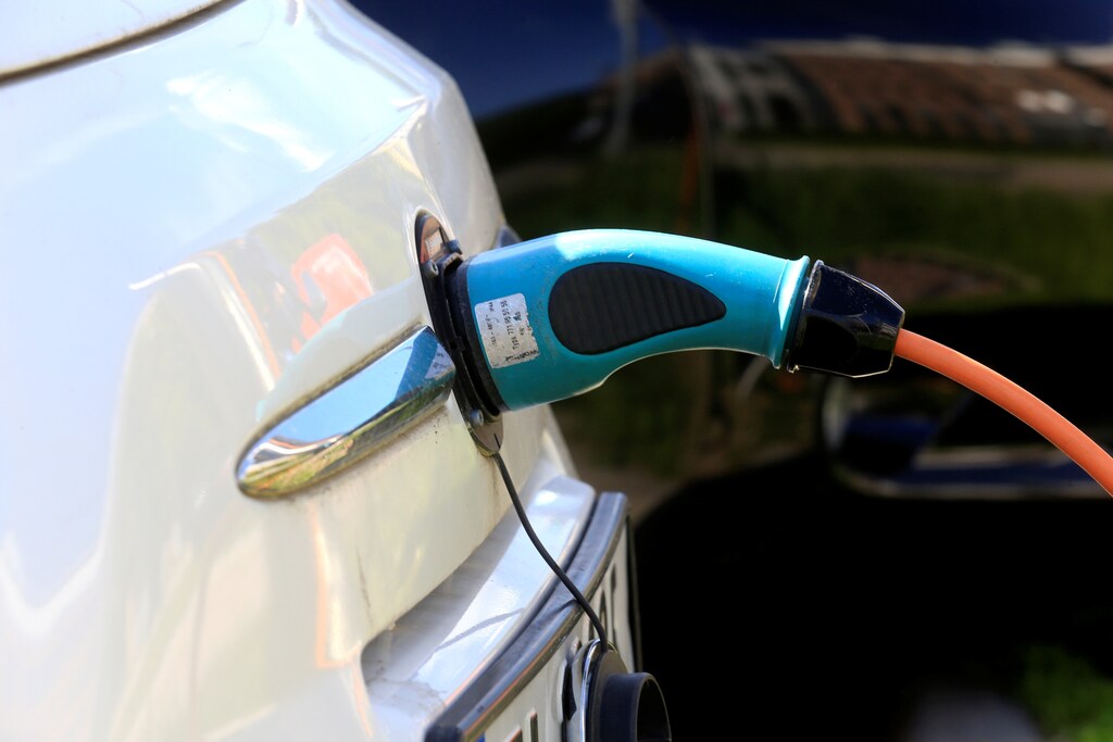 An electric car is charged at a parking lot in Oslo, Norway.