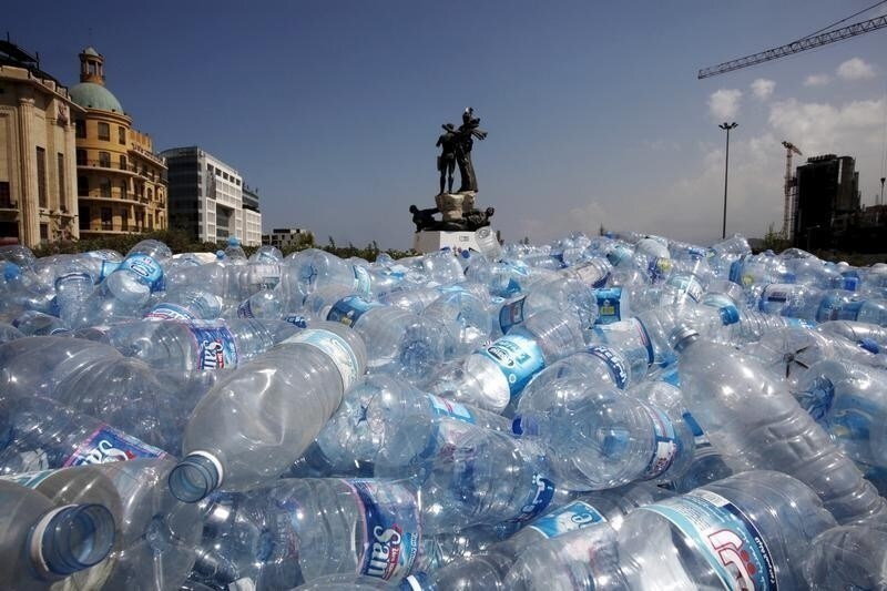 Water bottles are gathered to be recycled near a statue in Martyrs' Square in Beirut, Lebanon August 25, 2015.