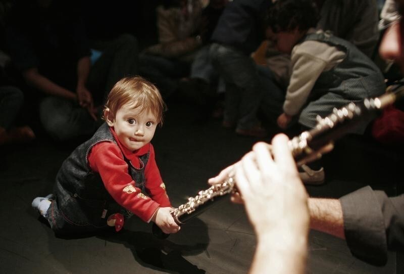 A baby grabs a clarinet of a performer of "Companhia Musicalmente" group during a concert for babies in Sintra, near Lisbon April 19, 2009. The baby concerts were created in 1998 by a group of musicians in Portugal inspired by the Music Learning Theory of North American author Edwin Gordon. The group wanted to give infants a first experience listening to live music in a free environment, where they can play and interact with the performers, other babies, parents and relatives