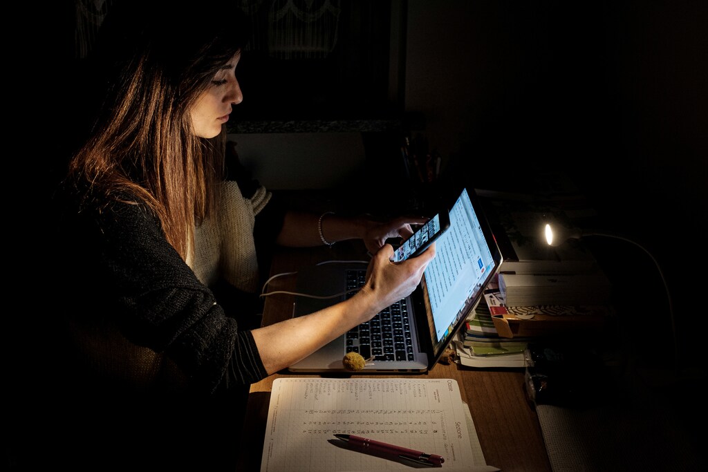 Life in lockdown: Chiara Zuddas, 31, works on her laptop at home in San Fiorano, one of the original 'red zone' towns in northern Italy that have been on lockdown since February, in this picture taken by her husband, schoolteacher Marzio Toniolo, March 27, 2020. Toniolo has been documenting what life has been like for his family since quarantine began for them weeks before the rest of the country. Picture taken March 27, 2020. Marzio Toniolo/via REUTERS THIS IMAGE HAS BEEN SUPPLIED BY A THIRD PARTY. MANDATORY CREDIT - RC2EUF900M5P