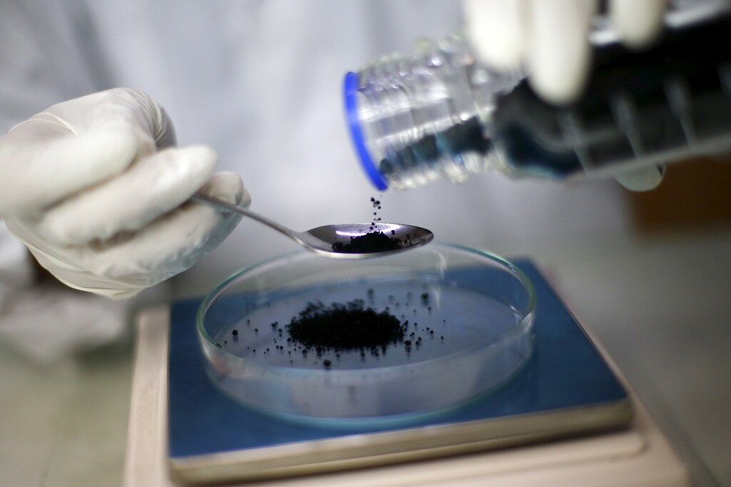 A worker weighs graphene, which is used by biochemists to develop a possible Zika-repellent clothes detergent additive, at "Grupo Avance" (Advance Group) laboratory in Santiago, March 4, 2016.