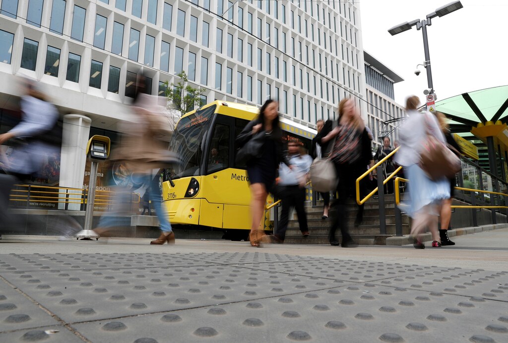 Commuters make there way through the streets in Manchester, Britain May 24, 2017. REUTERS/Darren Staples - RTX37CLE
