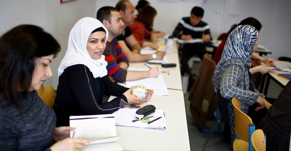 Migrants attend a lesson at the 'Institute for Intercultural Communication' in Berlin
