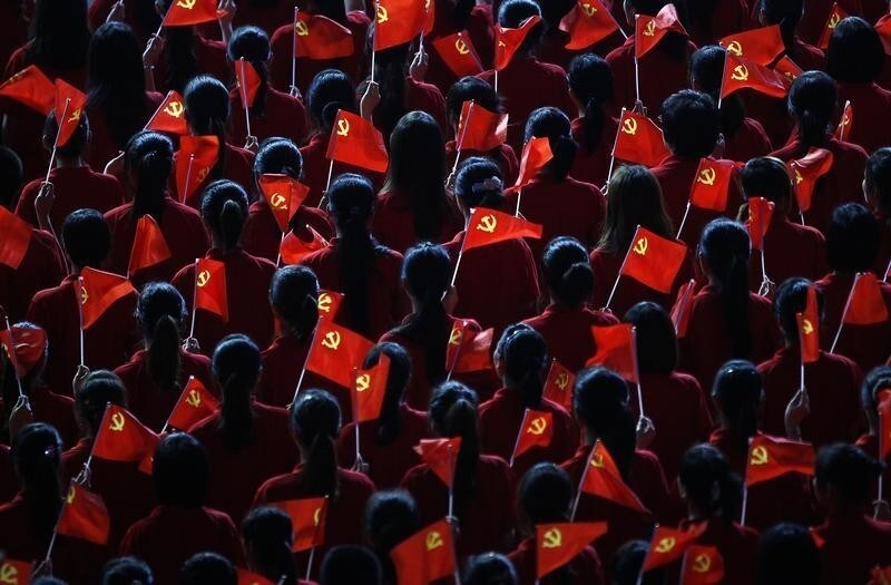 Performers hold flags of the Communist Party of China (CPC) during an event to celebrate the upcoming 90th anniversary of the founding of the party, at the Mercedes-Benz Arena in Shanghai June 30, 2011.