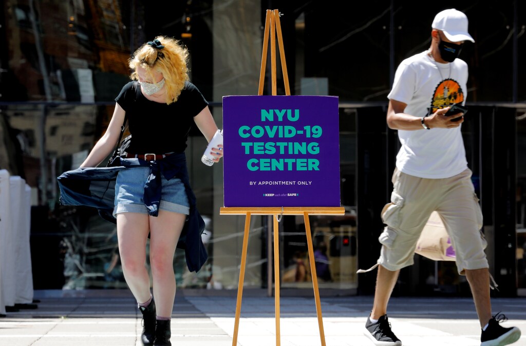 People wear protective masks as they exit a testing site for the coronavirus disease (COVID-19).