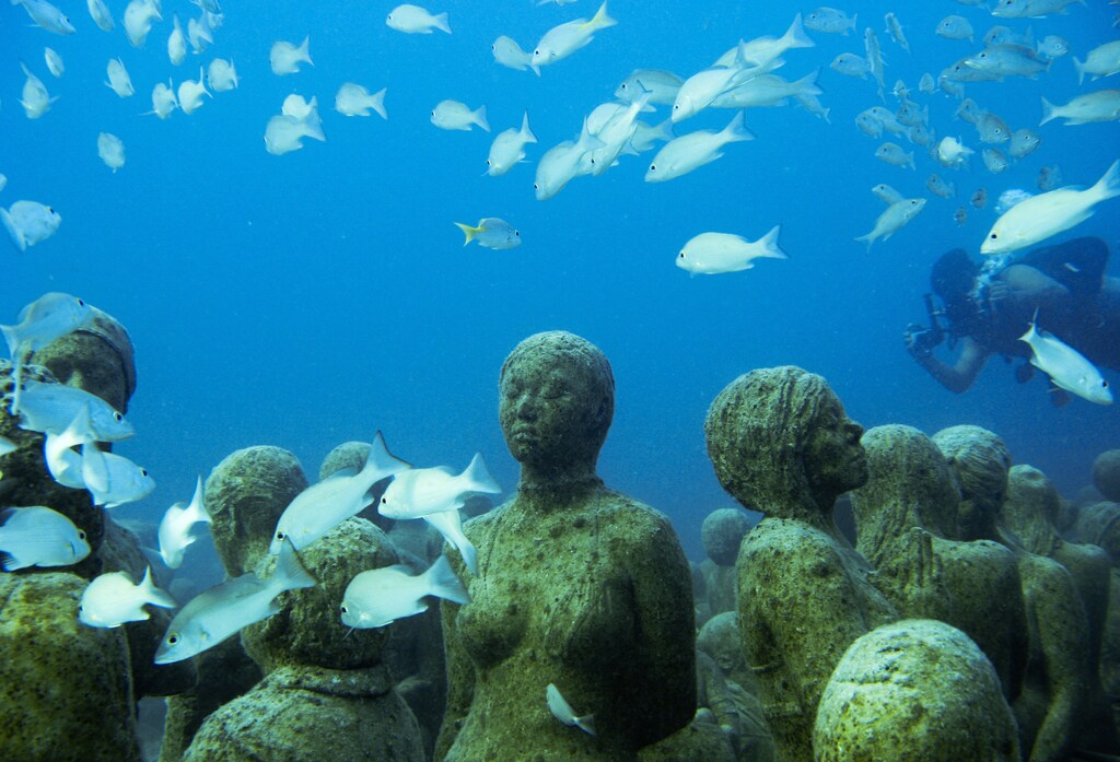 An underwater sculpture installation "The Silent Evolution" by British artist Jason de Caires Taylor is seen between Cancun and Isla Mujeres December 11, 2010. Taylor used 'life casts' made from materials that encourage coral growth to build the installation on the sea bed off the coast of Cancun. The installation will form a new home for a variety of aquatic creatures at the Cancun and Isla Mujeres National Marine Park and is designed to reduce the impact over half a million tourists have on the area's natural reefs every year, the artist said. Picture taken December 11, 2010. REUTERS/Jorge Silva