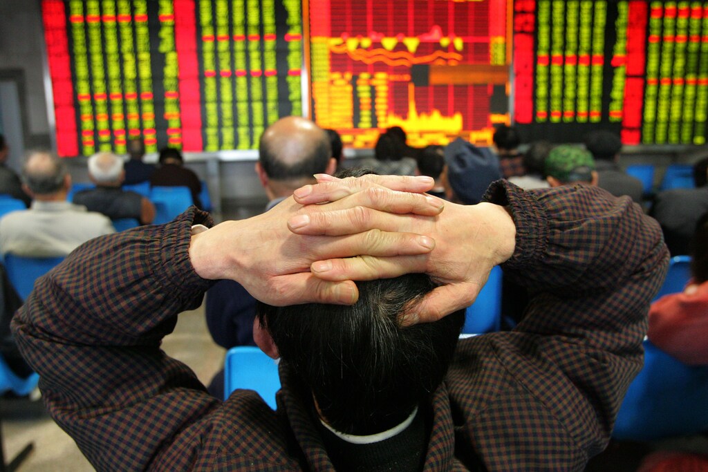A Chinese investor looks at share prices at a securities exchange in Shanghai March 28, 2005. China's shares hit a fresh six-year low on Monday after aviation stocks, including Shanghai Airlines Co. Ltd. dived as worries persisted over potentially higher jet fuel prices. The Shanghai composite index slipped 0.5 percent to end at 1,200.113 points. It had fallen as much as 1.7 percent in the early afternoon to an intraday trough of 1,185.456 - the index's lowest since a mark of 1,164.90 set on May 24, 1999. REUTERS/Claro Cortes IV CC/TZ - RP6DRMSJYYAB
