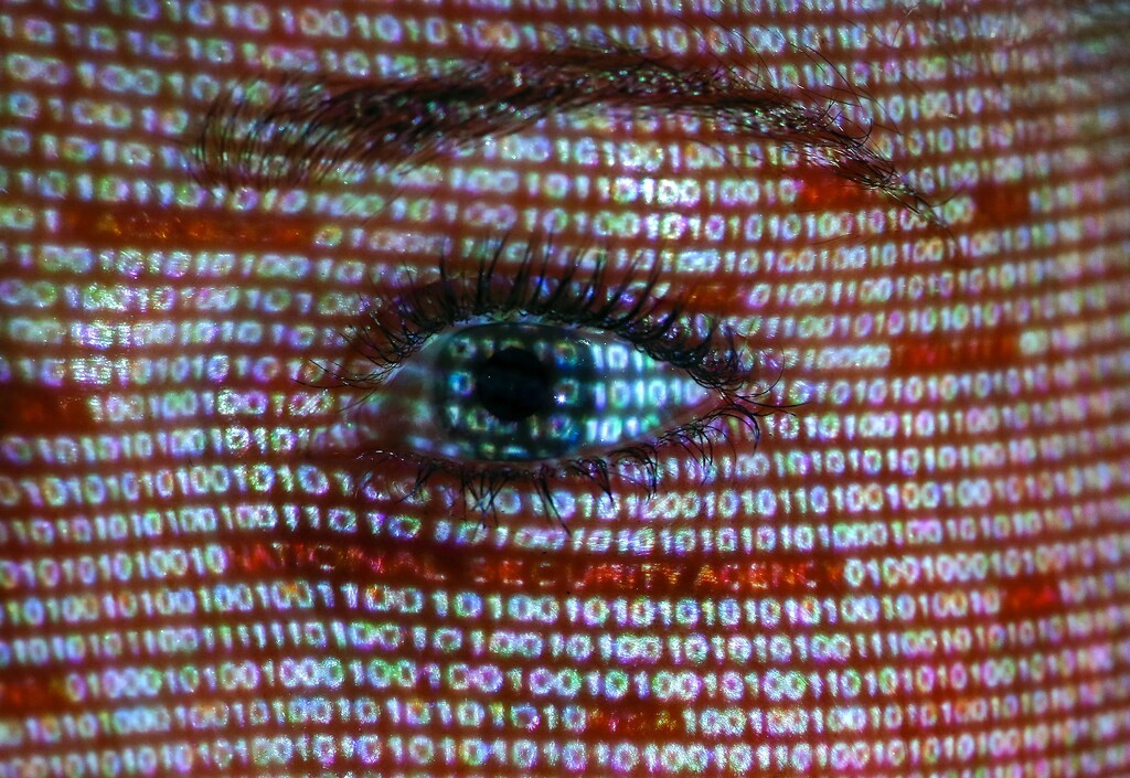 An illustration picture shows a projection of text on the face of a woman in Berlin, June 12, 2013. The European Union's chief justice official has written to the U.S. attorney general demanding an explanation for the collection of foreign nationals' data following disclosures about the "PRISM" spy programme. REUTERS/Pawel Kopczynski (GERMANY - Tags: SOCIETY POLITICS TPX IMAGES OF THE DAY) - BM2E96C197C01