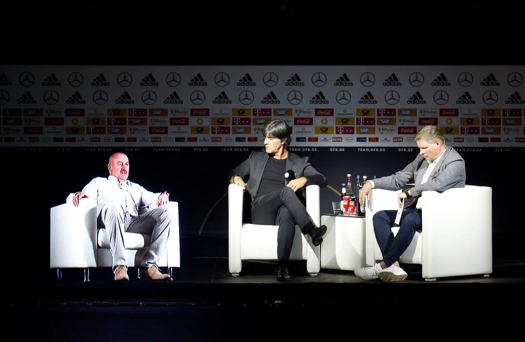 Soccer Football - Germany - Joachim Loew Press Conference - German Football Museum, Dortmund, Germany - May 15, 2018 Germany coach Joachim Loew and team manager Oliver Bierhoff with a hologram of Russia coach Stanislav Cherchesov during the press conference REUTERS/Leon Kuegeler - RC181B9979E0