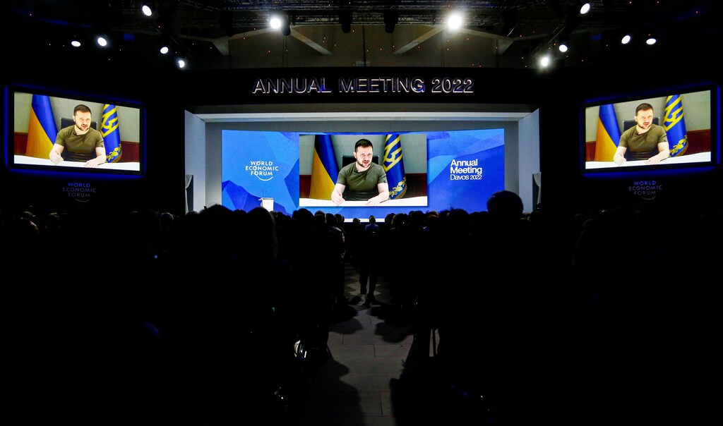 Davos 2022: Ukraine's President Volodymyr Zelenskyy is seen on a screen as he delivers a video address to the delegates of the World Economic Forum (WEF) in Davos, Switzerland May 23, 2022. REUTERS/Arnd Wiegmann