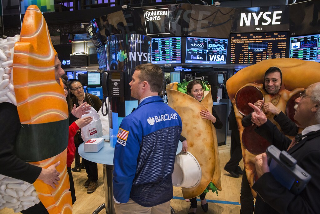People dressed in food-themed costumes walk on the floor of the New York Stock Exchange to celebrate the IPO of GrubHub in New York April 4, 2014. Shares of GrubHub Inc, the biggest U.S. online food-delivery service, rose as much as 57 percent in its market debut as investors scrambled for a piece of the fast-growing consumer internet company. REUTERS/Lucas Jackson (UNITED STATES - Tags: BUSINESS FOOD) - RTR3JYX4
