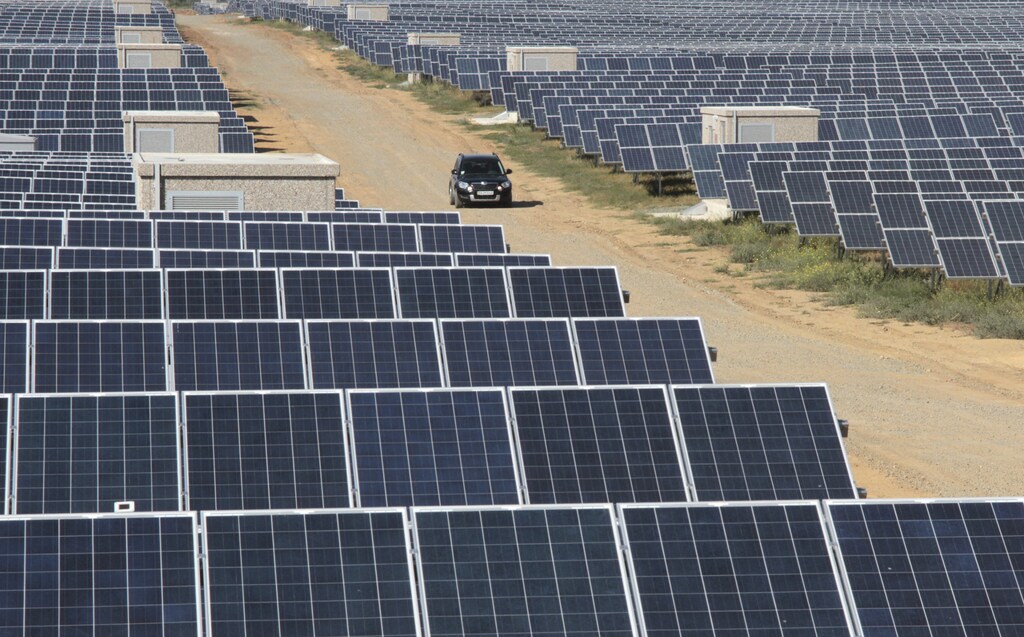 A car drives along the territory of a solar energy power station near the Okhotnikovo village in the Crimea's Saksky district September 16, 2011. The solar power plant is capable of producing 25 thousand megawatt-hours of environmentally clean electrical energy per year, according to local media. REUTERS/Stringer (UKRAINE - Tags: ENERGY ENVIRONMENT) - GM1E79H027W01