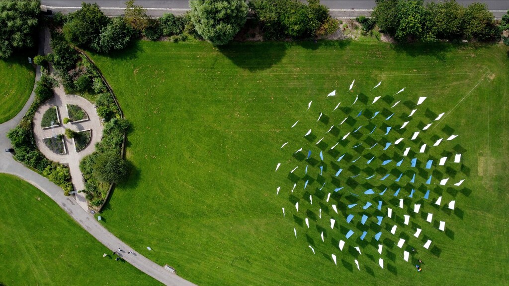 People visit Luke Jerram's "In Memoriam", a temporary memorial artwork for all those who lost their lives due to COVID-19, in Seaton Carew Park, Hartlepool, Britain August 20, 2021. Picture taken with drone. REUTERS/Lee Smith - RC219P9J2V4G