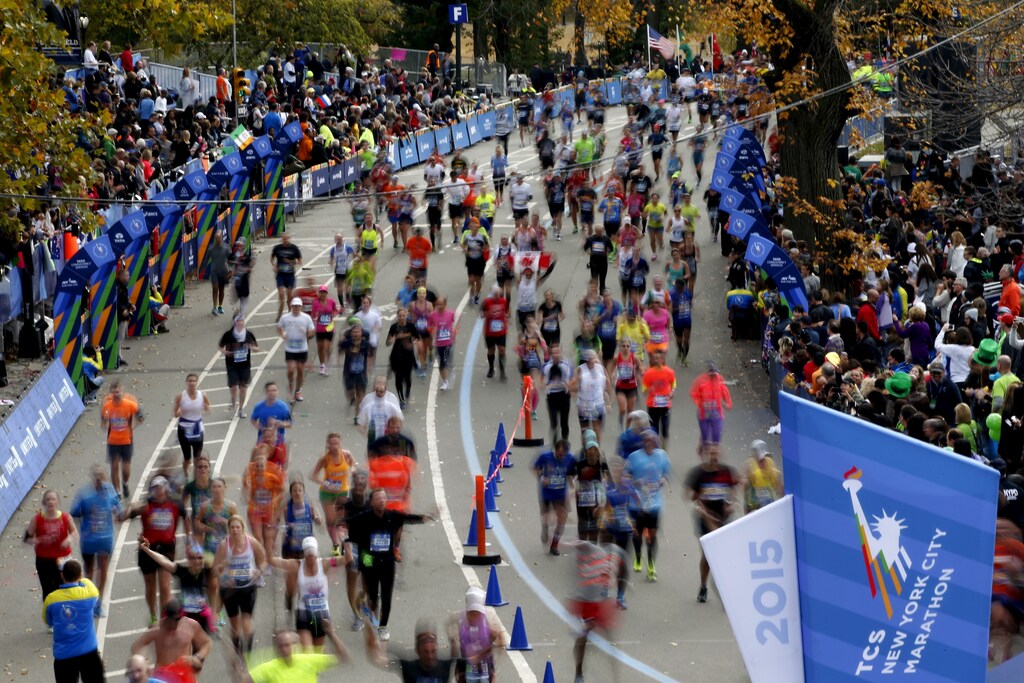 Runners run across the finish line at the 2015 New York City Marathon in New York's Central Park, November 1, 2015. Picture taken with slow shutter speed. REUTERS/Mike Segar - GF20000042209