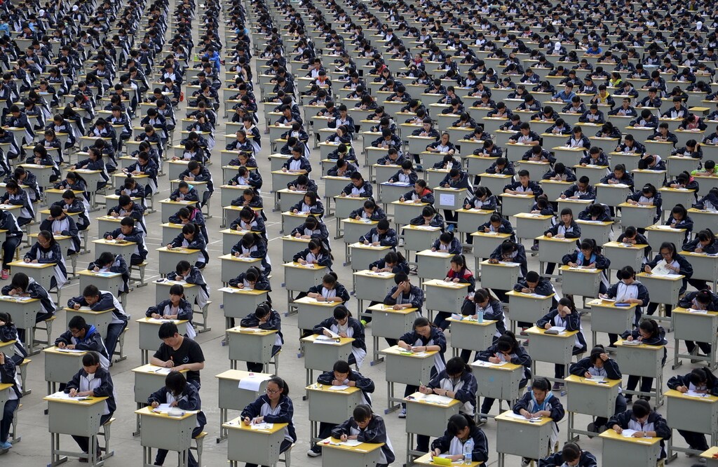 Students take an examination on an open-air playground at a high school in Yichuan, Shaanxi province April 11, 2015. More than 1,700 freshmen students took part in the exam on Saturday, which was the first attempt by the school to take it in open-air. The school said the reasons was due to the insufficient indoor space and also that it could be a test of the students' organizing capacity, local media reported. Picture taken April 11, 2015. REUTERS/Stringer TPX IMAGES OF THE DAY - GF10000056535