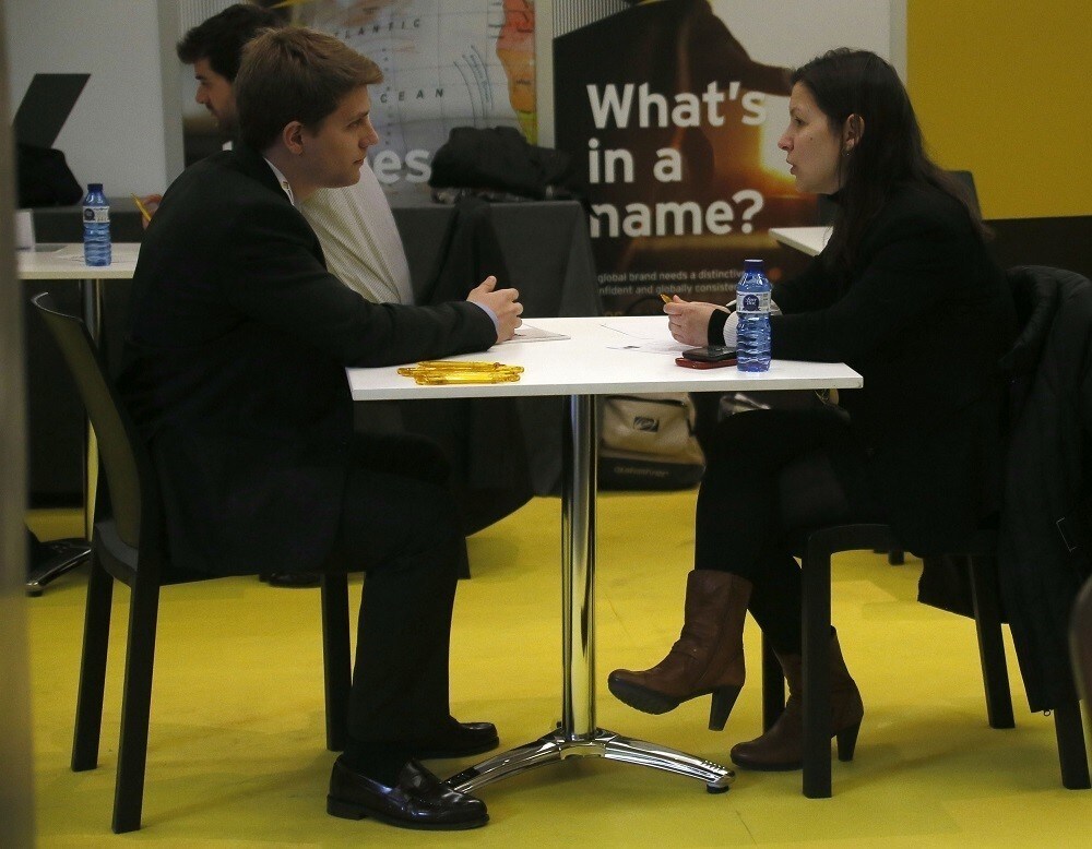 An attendee is interviewed by a company representative during the JOBarcelona'14 at the Palau de Congressos de Catalunya in Barcelona, February 18, 2014. JOBarcelona'14 is a two-day job fair targeted at university graduates. REUTERS/Gustau Nacarino (SPAIN - Tags: EDUCATION BUSINESS EMPLOYMENT) - RTX191YP