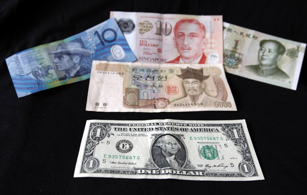 A U.S. dollar note (bottom) is pictured alongside other currencies including (L-R) the Australian Dollar, Singapore Dollar, Korean Won and China's Yuan in this picture illustration taken in Washington, October 14, 2010. The U.S. dollar index hit the year's low and world stocks were modestly higher on Thursday after Singapore let its currency strengthen, spurring gains in most major currencies against the struggling greenback. The Australian dollar, which boasts the highest yield among major currencies, soared to a 28-year high at $0.9994, and poised to near parity. REUTERS/Jason Reed (UNITED STATES - Tags: BUSINESS) - GM1E6AF05WS01